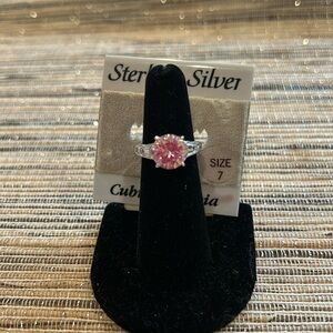 Pink round cubic done with two baguette